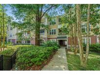 Inviting condominium exterior featuring manicured landscaping and charming architectural details at 600 Bucksley Ln # 106, Charleston, SC 29492