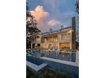 Luxury home featuring a swimming pool with lounge chairs and beautiful outdoor living spaces at 967 Royall Ave, Mount Pleasant, SC 29464