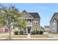Charming two-story home with a brick facade, welcoming front porch, and a well-maintained landscaped yard at 109 Pavilion St, Summerville, SC 29483