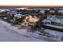 A stunning beachfront home with private pool, multiple balconies, and panoramic ocean views at sunset at 112 Ocean Blvd, Isle of Palms, SC 29451