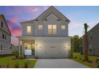 Charming two-story home featuring a two-car garage and appealing architectural details at 1724 Grovehurst Dr, Charleston, SC 29414