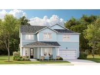 Charming two-story home with light blue siding, a covered porch, and a well-manicured front lawn at 207 Denham St, Summerville, SC 29486