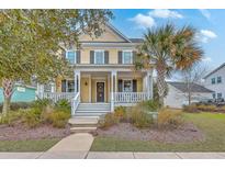 Charming yellow two-story home with a welcoming front porch and beautifully landscaped front yard at 3713 Maidstone Dr, Mount Pleasant, SC 29466