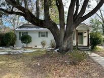 Charming single-story home with a beautifully landscaped front yard and mature trees at 5110 Temple St, North Charleston, SC 29405