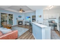 Inviting living room featuring a fireplace, balcony, and seamless flow into the modern kitchen at 60 Fenwick Hall Allee # 234, Johns Island, SC 29455