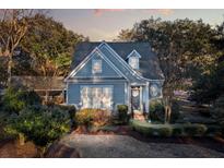 Charming home with beautiful landscaping, a welcoming front door, and a mix of trees and bushes at 114 Colleton Ave, Summerville, SC 29483