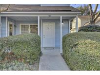 Charming front porch with a white door, well-maintained landscaping, and inviting entrance at 1203 Meadow Park Ln # B, Mount Pleasant, SC 29464