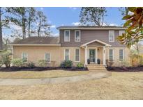 Charming two-story brick and siding home with landscaped front yard and welcoming entrance at 1541 Hutton Pl, Charleston, SC 29407