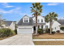 Charming two-story home featuring a well-manicured lawn and driveway leading to an attached two-car garage at 1821 Great Hope Dr, Mount Pleasant, SC 29466
