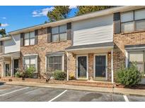 Inviting two-story townhouse with brick facade, black shutters, well-maintained landscaping, and dedicated parking spaces at 1910 Tropicana Rd # 9-D, North Charleston, SC 29406