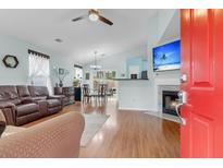 Inviting living room featuring a fireplace, wood floors, and comfortable seating, creating a cozy and welcoming atmosphere at 195 Droos Way, Charleston, SC 29414