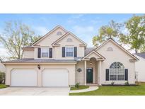 Charming two-story home featuring a two-car garage, manicured lawn, and inviting front porch at 204 Candleberry Cir, Goose Creek, SC 29445