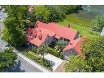 Stunning aerial view of the home showcasing the red roof, lush landscaping, and charming curb appeal at 204 Live Oak Dr, Mount Pleasant, SC 29464