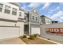 View of the exterior of the townhouse, with an attached garage and a PODS moving container visible at 3066 Emma Ln, Mount Pleasant, SC 29466
