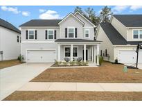 Charming two-story home with a welcoming front porch and well-manicured lawn at 491 Richfield Way, Summerville, SC 29486