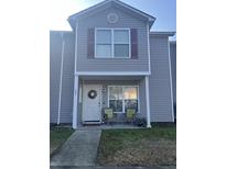 Charming two-story home with a welcoming front porch featuring comfortable seating and a decorative wreath at 527 Travelers Blvd, Summerville, SC 29485