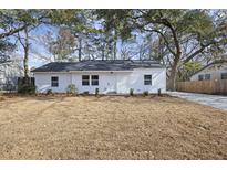 Charming renovated one-story home featuring a new roof, white siding, and mature trees in front at 5816 Sedgefield Dr, Hanahan, SC 29410