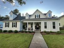 Charming single-Gathering home with a welcoming front porch, manicured lawn, and classic architectural details at 108 Bateaux Dr, Summerville, SC 29483