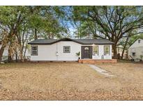 Charming single-story home featuring neutral paint, black trim, and a cozy front porch at 1112 Melvin Dr, Hanahan, SC 29410