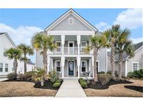 Charming two-story home with a welcoming porch, swing, and lush landscaping at 119 Philips Park St, Summerville, SC 29486