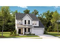 Charming two-story home featuring a covered porch, black shutters and a two-car garage at 131 Threaded Fern St, Summerville, SC 29485