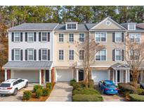 Charming townhouses with garages and well-maintained landscaping creates a welcoming curb appeal at 136 Fair Sailing Rd, Mount Pleasant, SC 29466