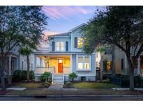 Charming two-story home features a welcoming front porch and professionally landscaped yard at 1433 Lettered Olive Ln, Mount Pleasant, SC 29464