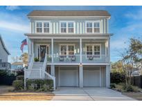 Charming two-story home with a spacious porch, two car garage, and a well-manicured front yard at 1464 Stratton Pl, Mount Pleasant, SC 29466