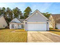 Charming single-story home featuring light-gray siding, manicured lawn, and attached two-car garage at 1475 Coopers Hawk Dr, Hanahan, SC 29410