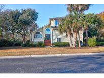 Charming two-story home with mature trees, landscaping, and a brick staircase at 1784 Omni Blvd, Mount Pleasant, SC 29466