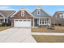 Charming single-Gathering home featuring a stone facade, two-car garage, and covered front porch at 2006 Barn Swallow Rd, Summerville, SC 29483