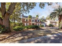 Charming two-story brick home featuring white shutters, a well-manicured lawn, and mature trees at 210 Lakeview Dr, Summerville, SC 29485