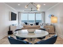 Bright living room with ocean view, stylish furniture, and a modern light fixture at 2473 Shipwatch Rd, Kiawah Island, SC 29455