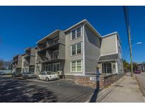 A view of the building showcasing its multi-story design and exterior architecture under a clear blue sky at 259 E Bay St # 1 C, Charleston, SC 29401