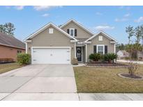 Charming single-Gathering home with a two-car garage, manicured lawn, and neutral colored siding at 319 Knawl Rd, Moncks Corner, SC 29461