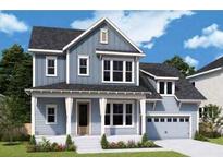 Charming two-story home with a covered front porch and manicured landscaping at 1195 Reserve Ln, Awendaw, SC 29429