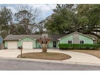 Charming single-story home with a light green exterior and a spacious two-car garage at 1227 Chuka Ct, Charleston, SC 29412