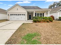 Charming single-story home with a two-car garage and manicured landscaping at 1556 Pixley St, Charleston, SC 29414