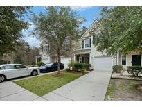 Charming townhomes with well-maintained lawns and driveways offer inviting curb appeal at 1706 Restoration Ct, Charleston, SC 29414