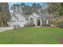 Charming single-story home featuring a two-car garage, a well-maintained lawn, and classic curb appeal at 2005 Carriage Way, Summerville, SC 29485