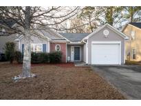 Charming one-story home featuring a single-car garage, well-maintained landscaping, and inviting curb appeal at 240 Island Green Rd, Goose Creek, SC 29445