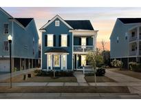 Charming two-story blue home with a second-story balcony and a well-manicured front yard at 2751 Rutherford Way, Charleston, SC 29414