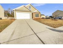 Charming home with neutral siding, attached garage and a long concrete driveway at 332 Cicadas Song Dr, Moncks Corner, SC 29461