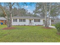 Charming white brick home with a lush front lawn and classic black shutters at 337 Cessna Ave, Charleston, SC 29407