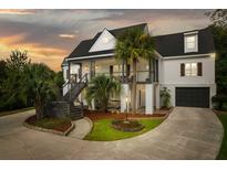 Stunning two-story home with a beautiful wraparound porch and manicured landscaping at 3592 Somerset Hills Ct, Mount Pleasant, SC 29466