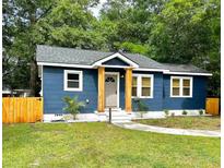 Charming home featuring a freshly landscaped front yard, updated windows, and a beautifully painted exterior at 4530 Holly St, North Charleston, SC 29405