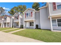 Charming townhomes featuring updated gray siding, red shutters, and well-maintained green lawn at 515 Travelers Blvd, Summerville, SC 29485