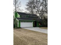 Two-story home featuring a large garage and a spacious driveway nestled under mature trees at 1137 Windsome Pl, Mount Pleasant, SC 29464