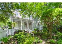 Charming two-story home with a welcoming front porch and lush, mature landscaping at 145 Jakes Ln, Mount Pleasant, SC 29464