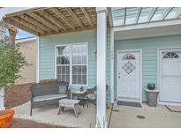 Inviting front porch featuring a seating area perfect for relaxing outdoors at 1608 Fetterbush Ln, Johns Island, SC 29455
